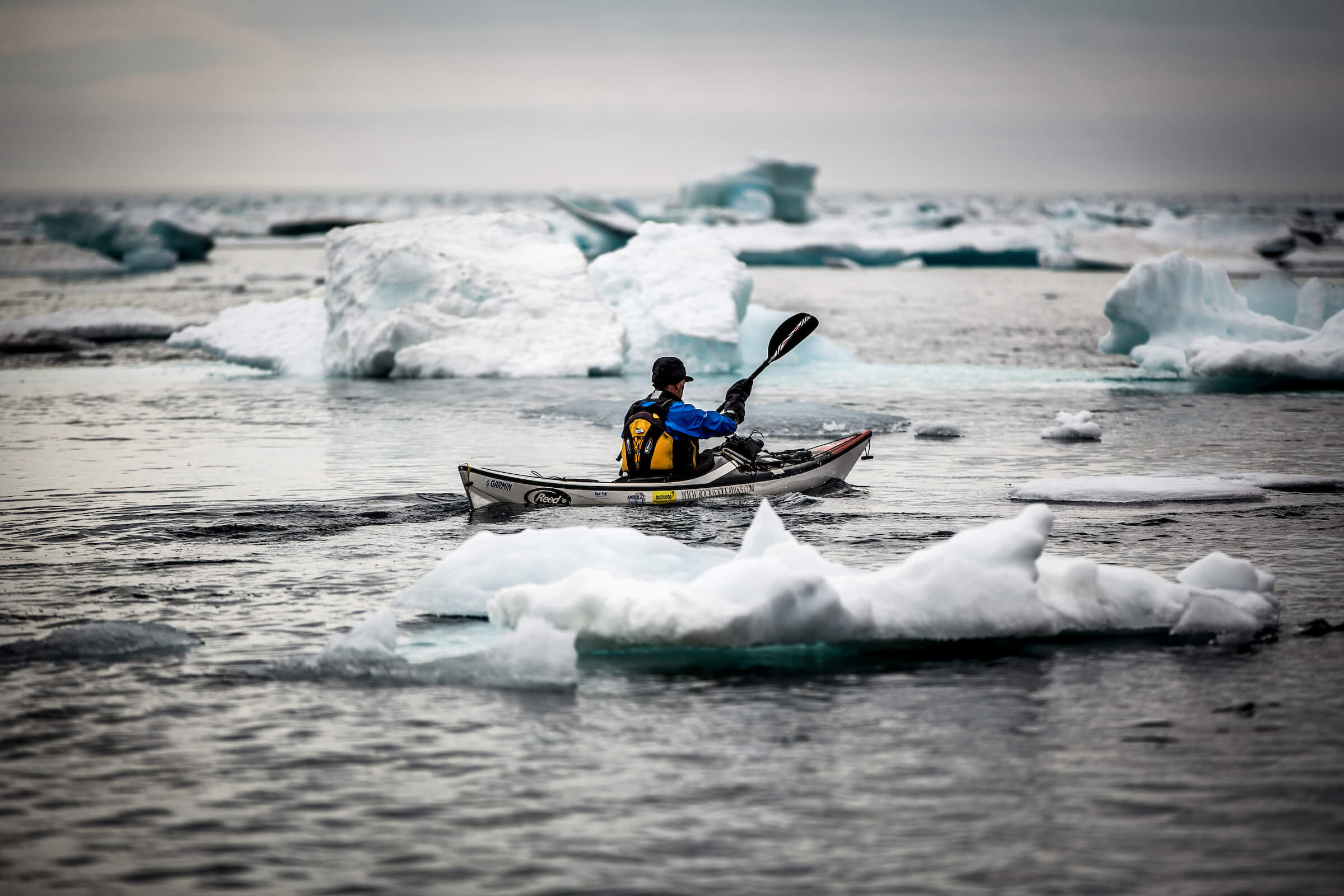 A sea kayaker among ice floes near Tasiilaq in East Greenland