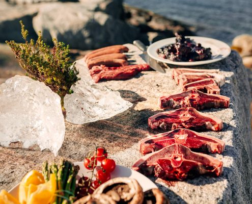 A selection of greenlandic meat being prepared on the rocks in Nuuk in Greenland. Photo by Rebecca Gustafsson - Visit Greenland