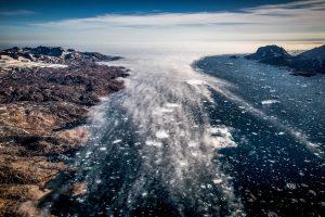 Fog creeping in to the Sermilik ice fjord in East Greenland seen from an Air Zafari flight. By Mads Pihl
