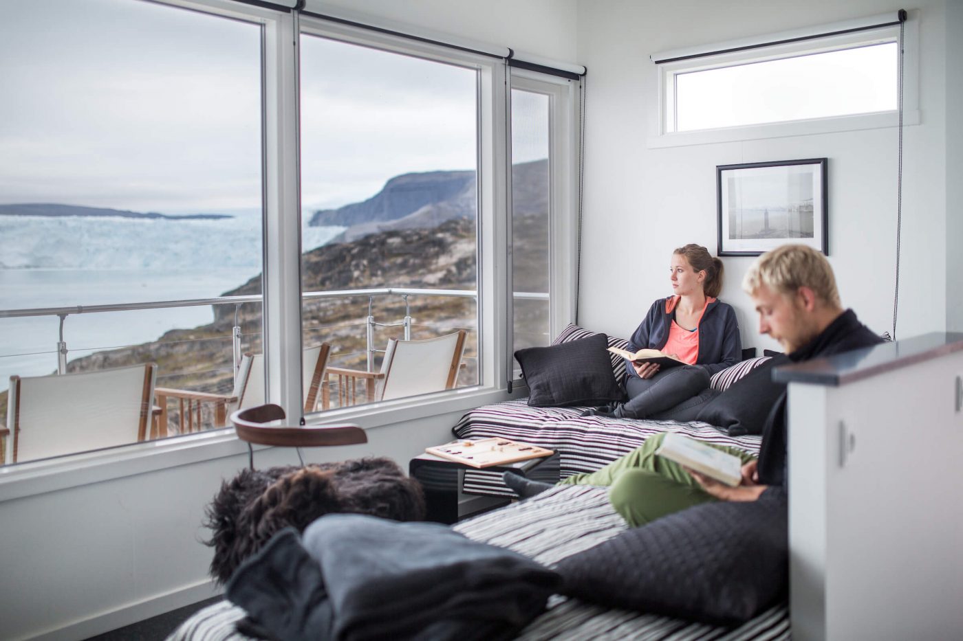 Guests enjoying a quiet moment in one of the Eqi Glacier Lodge comfort huts in Greenland. Photo by Mads Pihl, Visit Greenland