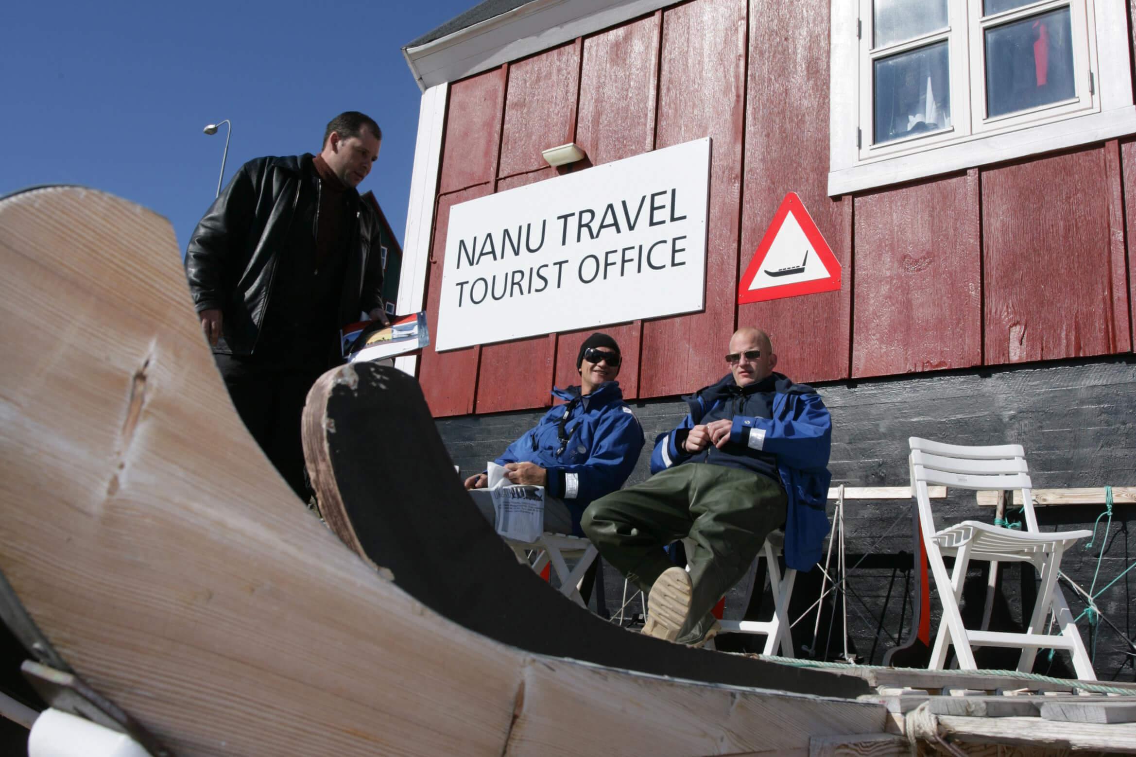 Three men enjoying the sun in front of Nanu Travel Tourist Office. Photo by Nanu Travel