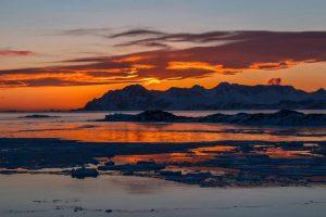 Sunset and small icebergs in East Greenland. Photo by Pirhuk - Greenland Expedition Specialists