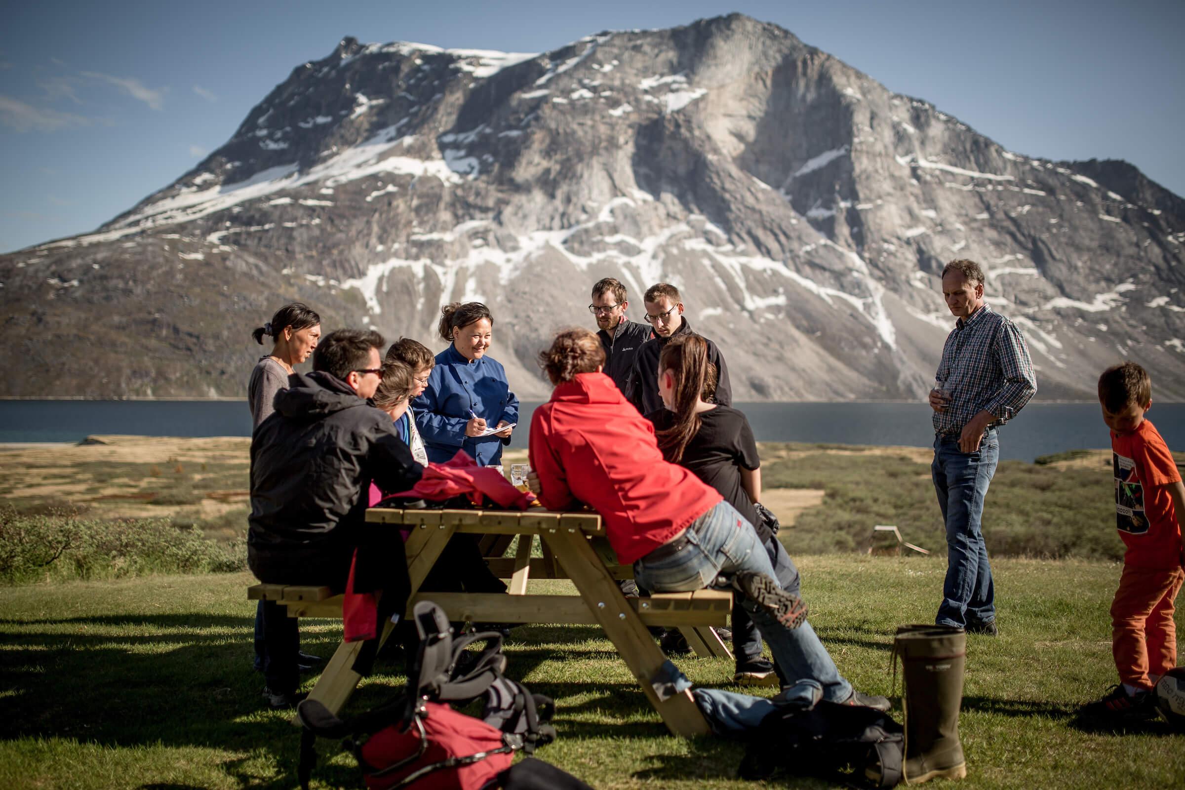 The waiter taking orders from guests at the Qooqqut Nuan restaurant in the fjord near Nuuk in Greenland. By Mads Pihl