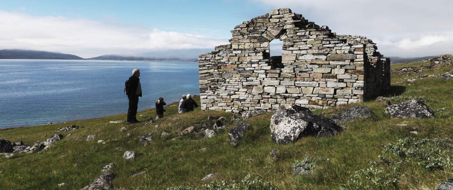 Travelers studying the 1000 year old Hvalsey church ruin in south Greenland not far from Qaqortoq. By David Trood