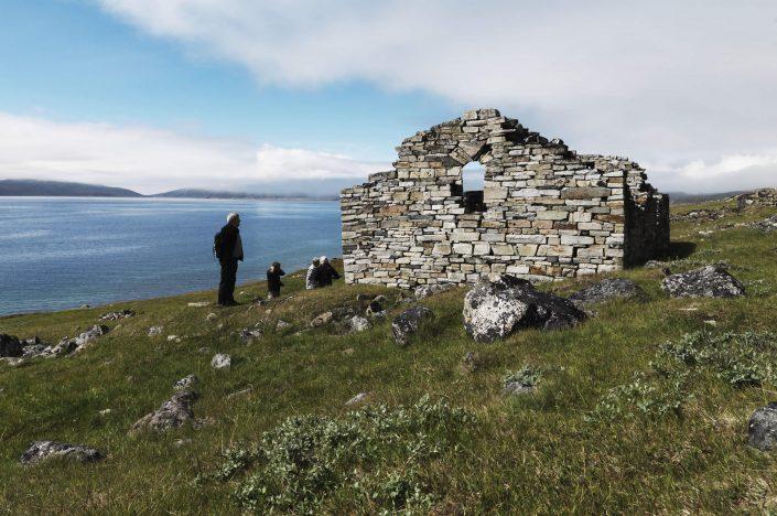 Travelers studying the 1000 year old Hvalsey church ruin in south Greenland not far from Qaqortoq. By David Trood
